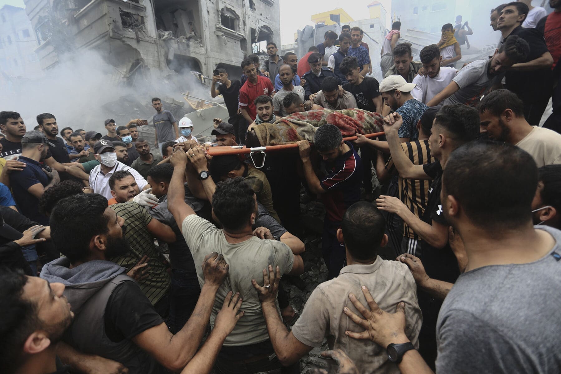 Palestinians remove a dead body from the rubble of a building after an Israeli airstrike - Source: CNN