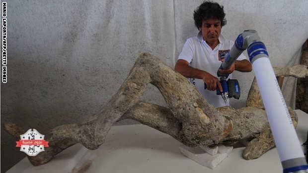 A restorer works with a laser scaner on a petrified victim of the eruption of Vesuvius volcano in 79 BC، as part of the restoration work and the study of 86 casts in the laboratory of Pompeii Archaeological Site، on May 20، 2015 in Pompeii. AFP PHOTO / MARIO LAPORTA (Photo credit should read MARIO LAPORTA/AFP/Getty Images)