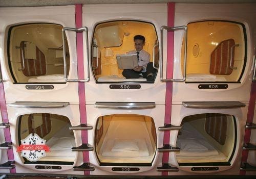 TOKYO - FEBRUARY 6: A visitor relaxes in a sleeping module at Tokyo's tube Hotel "Capsule Inn Akihabara" on February 6، 2007 in Tokyo، Japan. The two-square-meter sleep modules are equipped with a TV، Radio and Wireless LAN and are priced at 3500 yen per night. Uptil recently it has mainly been the office workers who stay at such tube hotels when they cannot go home، but recently they are attracting many foreign travellers due to their Japanese style. (Photo by Koichi Kamoshida/Getty Images)