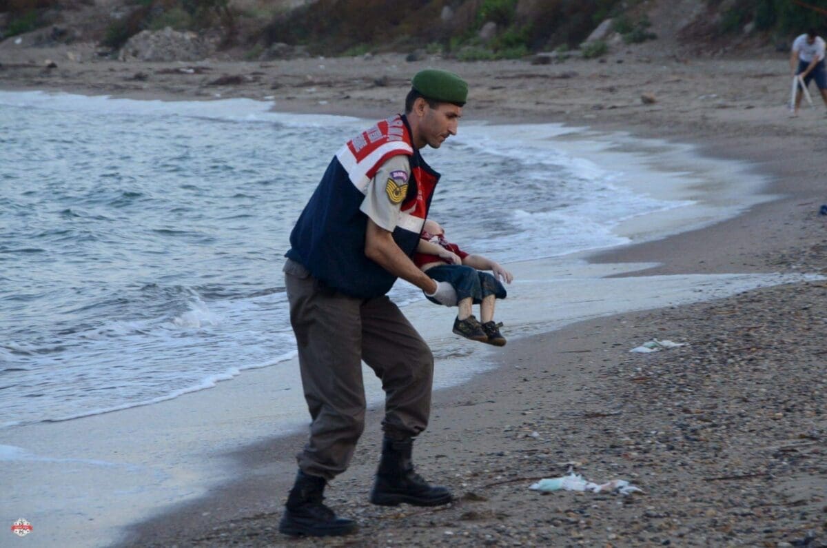 ATTENTION EDITORS - VISUAL COVERAGE OF SCENES OF DEATH OR INJURY A Turkish gendarmerie carries a young migrant، who drowned in a failed attempt to sail to the Greek island of Kos، in the coastal town of Bodrum، Turkey، September 2، 2015. At least 11 migrants believed to be Syrians drowned as two boats sank after leaving southwest Turkey for the Greek island of Kos، Turkey's Dogan news agency reported on Wednesday. It said a boat carrying 16 Syrian migrants had sunk after leaving the Akyarlar area of the Bodrum peninsula، and seven people had died. Four people were rescued and the coastguard was continuing its search for five people still missing. Separately، a boat carrying six Syrians sank after leaving Akyarlar on the same route. Three children and one woman drowned and two people survived after reaching the shore in life jackets. REUTERS/Nilufer Demir/DHA ATTENTION EDITORS - NO SALES. NO ARCHIVES. FOR EDITORIAL USE ONLY. NOT FOR SALE FOR MARKETING OR ADVERTISING CAMPAIGNS. TEMPLATE OUT. THIS IMAGE HAS BEEN SUPPLIED BY A THIRD PARTY. IT IS DISTRIBUTED، EXACTLY AS RECEIVED BY REUTERS، AS A SERVICE TO CLIENTS. TURKEY OUT. NO COMMERCIAL OR EDITORIAL SALES IN TURKEY.