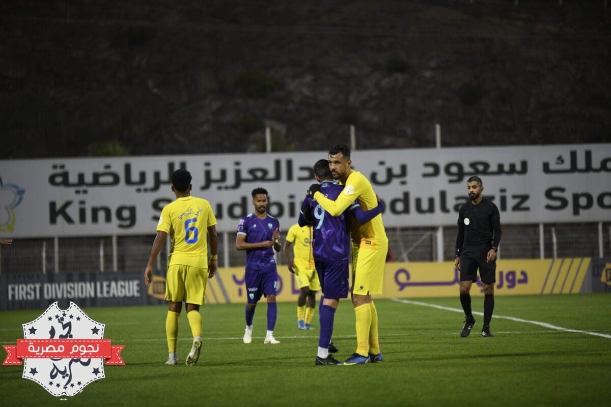 عناق لاعبي الأهلي والعين بعد انتهاء المباراة المؤجلة بينهما في دوري يلو السعودي